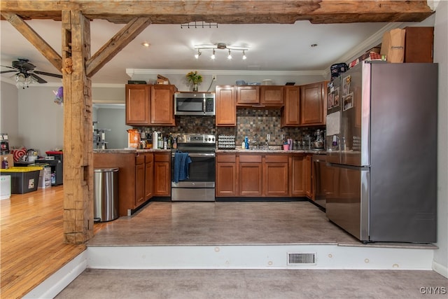 kitchen with appliances with stainless steel finishes, backsplash, crown molding, beam ceiling, and ceiling fan