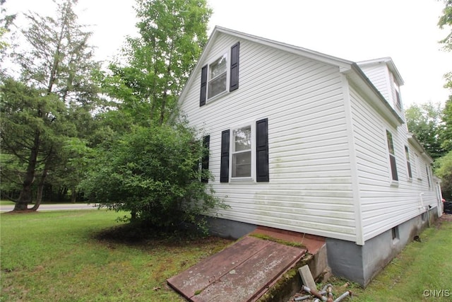 view of property exterior with a lawn