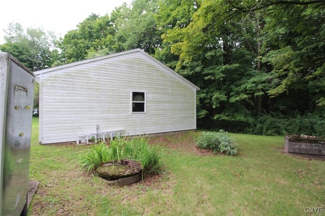 view of side of home with a lawn