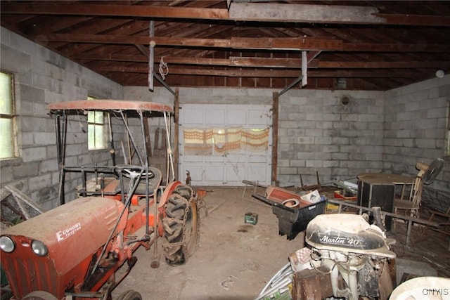 interior space featuring a garage and concrete block wall