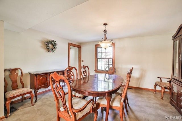 dining space with baseboards and light floors