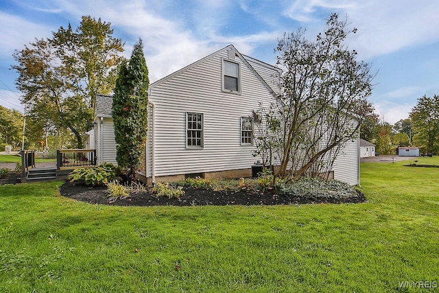 view of property exterior with a wooden deck and a lawn