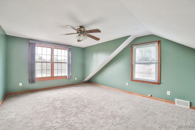 additional living space featuring a ceiling fan, carpet, vaulted ceiling, and baseboards