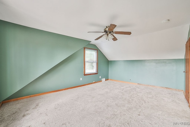 additional living space with carpet floors, vaulted ceiling, and ceiling fan