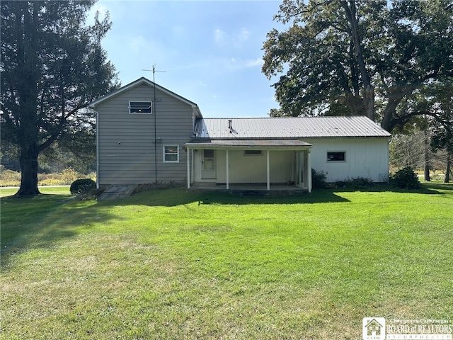 back of house with a lawn