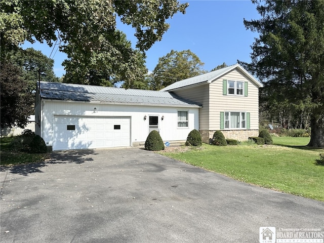 view of front of property with a garage and a front lawn