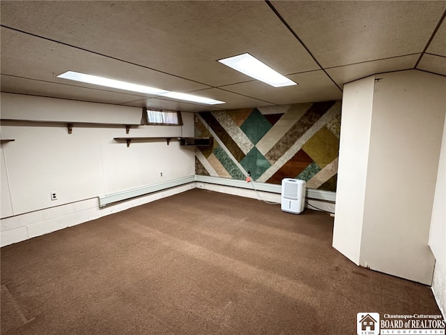 basement with a drop ceiling and carpet