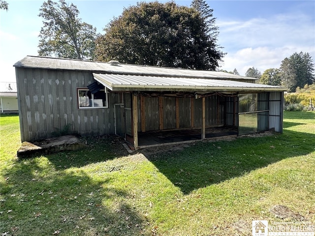 view of outbuilding featuring a lawn