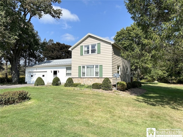 front facade featuring a front yard and a garage