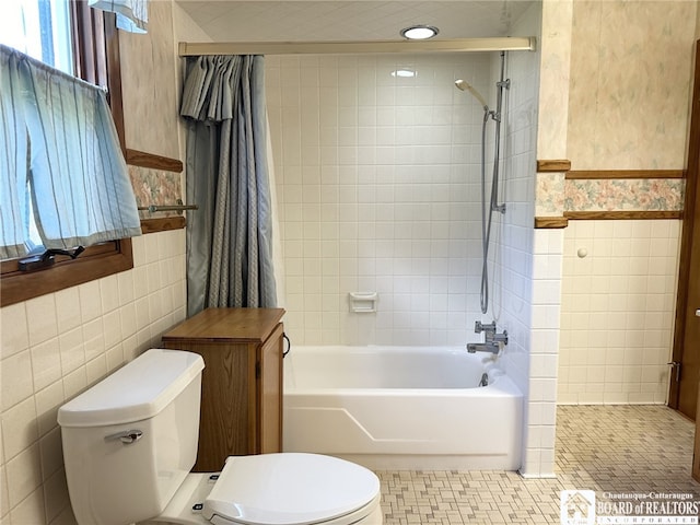 bathroom featuring tile walls, tile patterned floors, and toilet