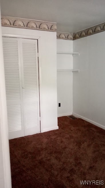 walk in closet with carpet