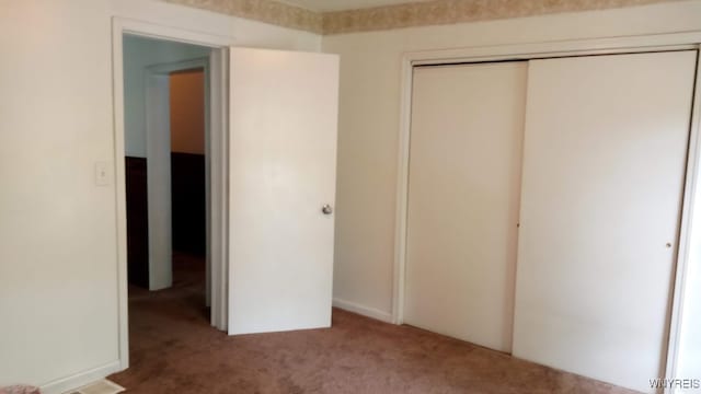 unfurnished bedroom featuring a closet and carpet floors