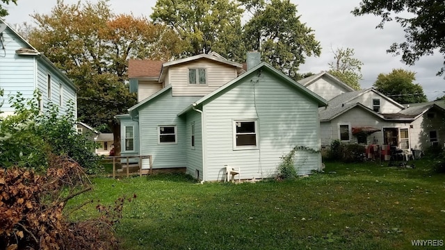 rear view of house with a lawn