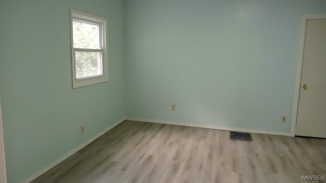 empty room with light hardwood / wood-style floors