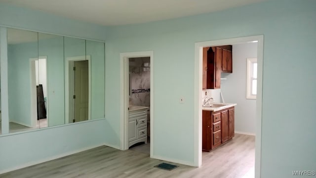 interior space featuring vanity and hardwood / wood-style flooring