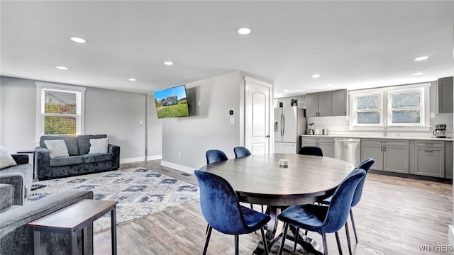 dining space featuring light hardwood / wood-style floors and sink