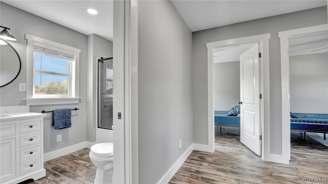 bathroom with hardwood / wood-style floors, vanity, and toilet