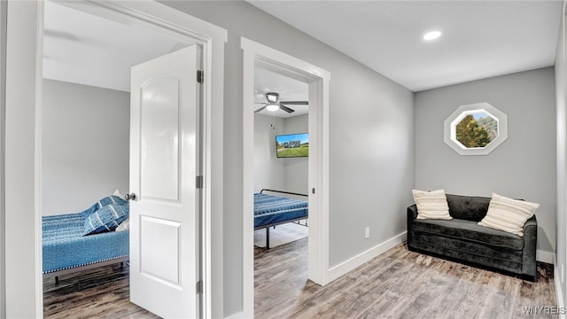 sitting room featuring ceiling fan and wood-type flooring