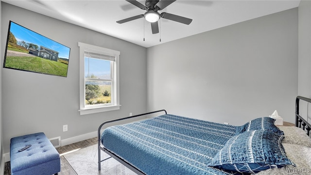 bedroom with hardwood / wood-style flooring and ceiling fan