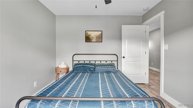 bedroom with ceiling fan and hardwood / wood-style flooring