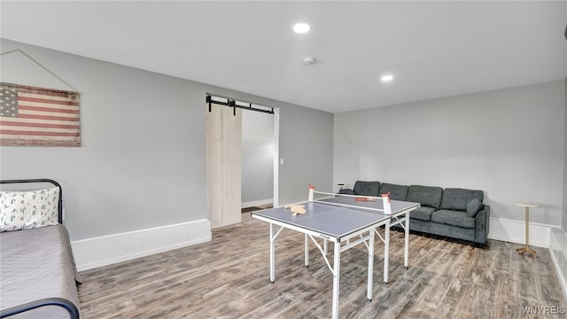 playroom with hardwood / wood-style floors and a barn door