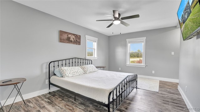 bedroom featuring ceiling fan and dark hardwood / wood-style flooring