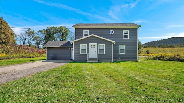 view of front of house with a front yard and a mountain view