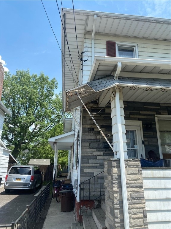 view of side of property featuring covered porch