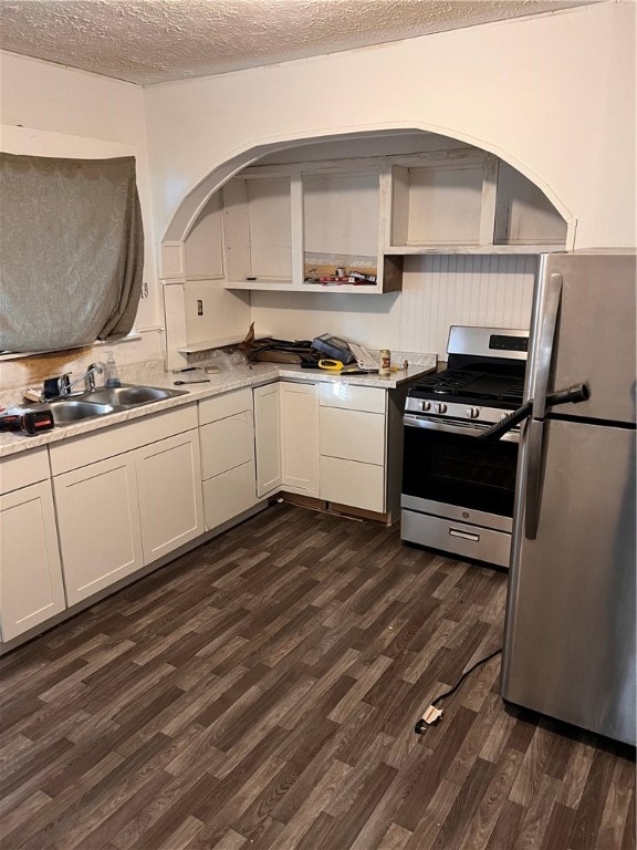 kitchen featuring a textured ceiling, stainless steel appliances, sink, and dark hardwood / wood-style flooring