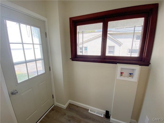 doorway with dark wood-type flooring