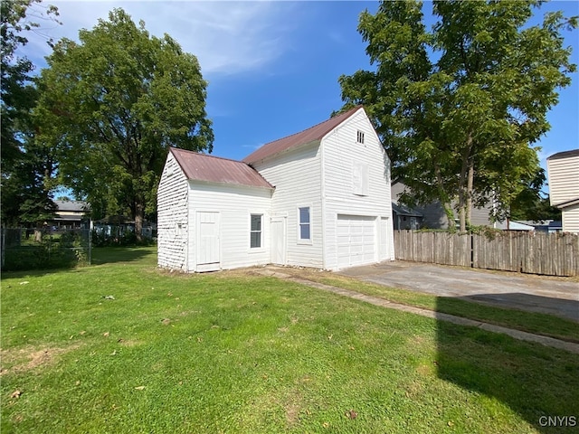 view of home's exterior featuring a lawn and a garage