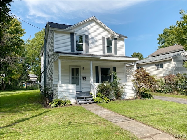 view of front property with a front lawn and covered porch