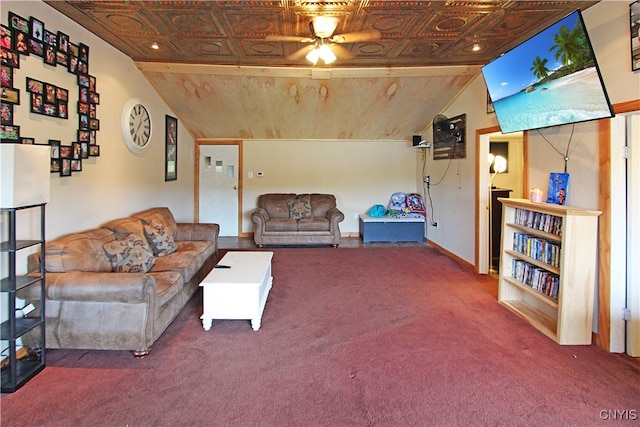 living room with ceiling fan, lofted ceiling, and carpet