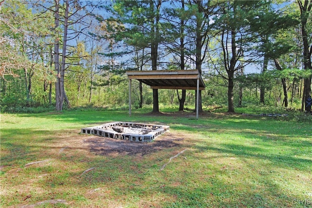 view of yard with a fire pit