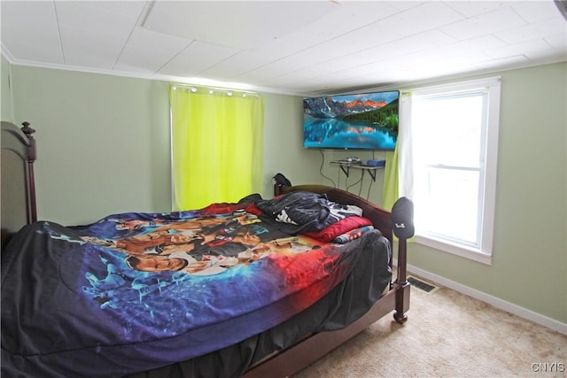 bedroom featuring ornamental molding, visible vents, light carpet, and baseboards