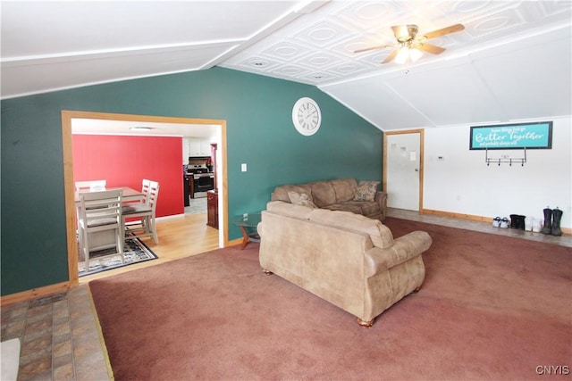 living area with carpet floors, lofted ceiling, ceiling fan, and baseboards