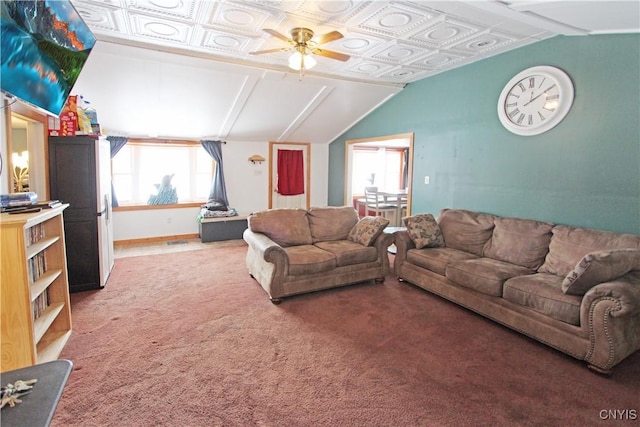 living area featuring carpet floors, an ornate ceiling, vaulted ceiling, and a ceiling fan