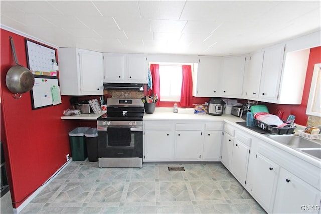 kitchen with light countertops, stainless steel range with electric cooktop, and white cabinetry