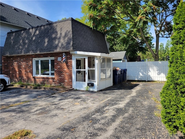 view of side of home featuring a sunroom