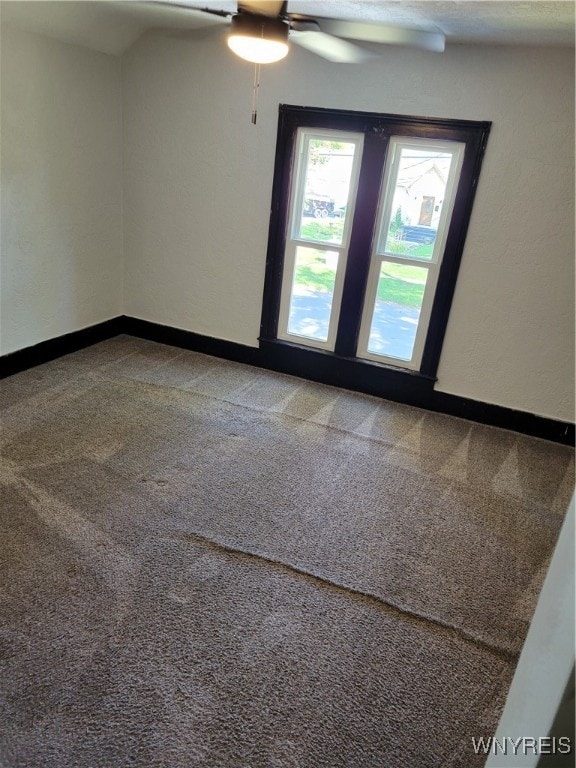 empty room featuring carpet flooring and ceiling fan