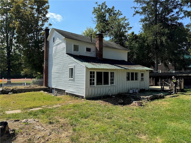 rear view of property with a lawn