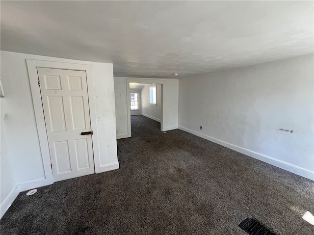 empty room with dark carpet