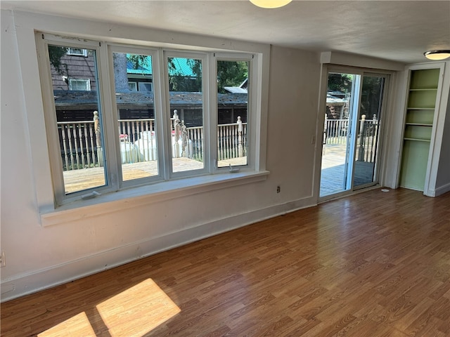 unfurnished room featuring hardwood / wood-style flooring