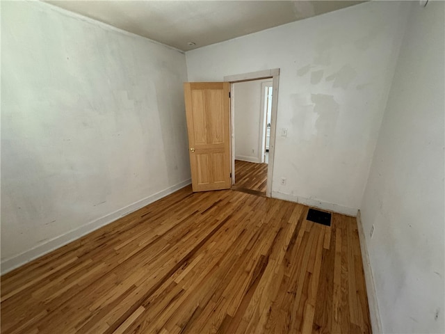 unfurnished room featuring hardwood / wood-style flooring