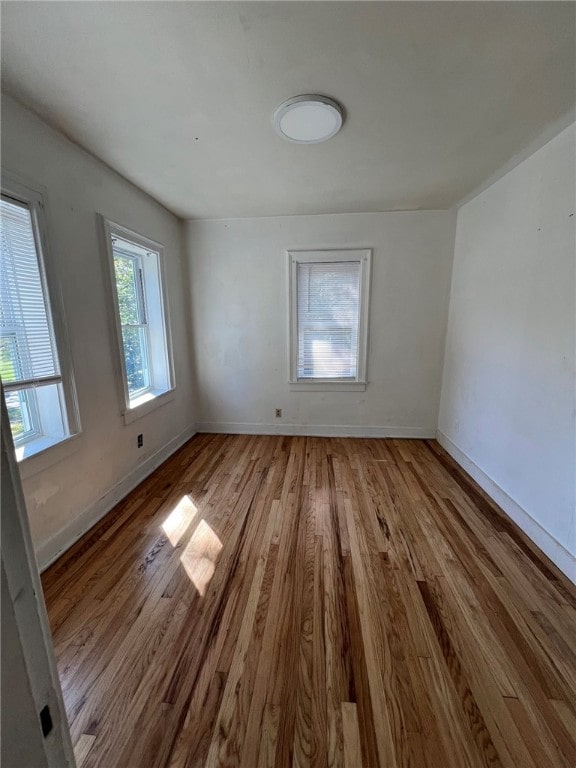 spare room with light wood-type flooring and a healthy amount of sunlight