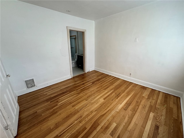 spare room with hardwood / wood-style floors