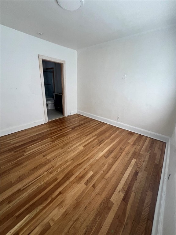 spare room featuring wood-type flooring