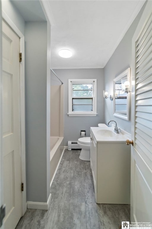 full bathroom with vanity, toilet, a baseboard radiator, hardwood / wood-style floors, and  shower combination