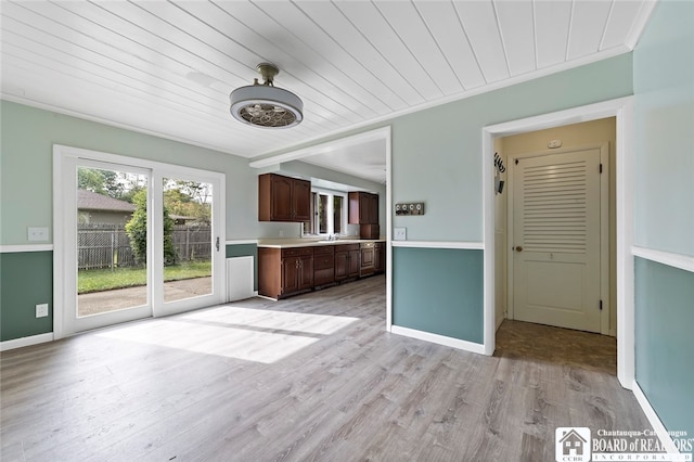 kitchen with wood ceiling, light wood-type flooring, dark brown cabinetry, and sink