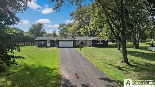 ranch-style house featuring a front yard and a garage